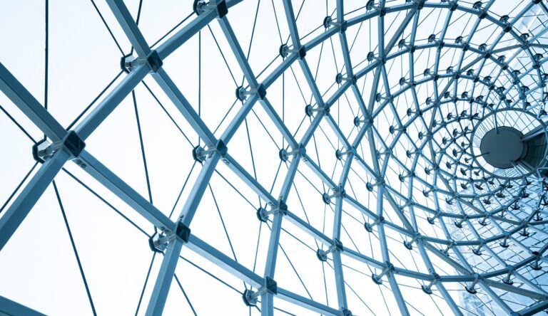 glass curved building supported by metal scaffolds