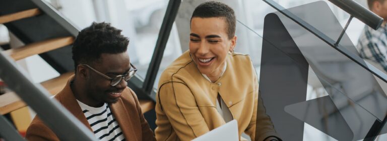 Colleagues collaborating in modern office with laptops